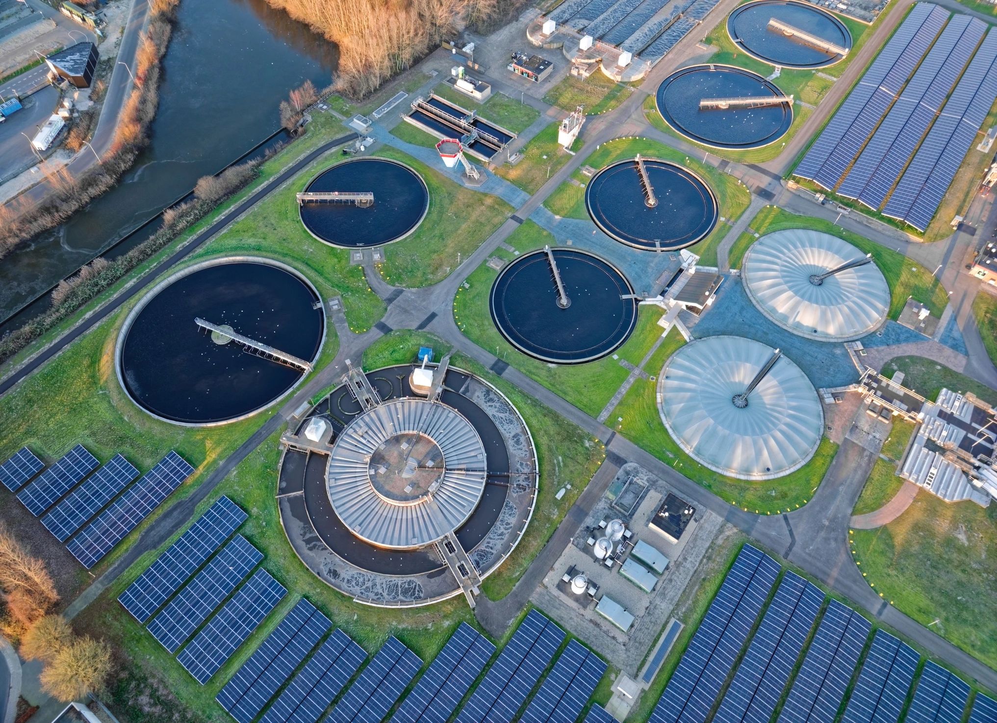 Aerial view of a modern wastewater treatment plant with solar panels
